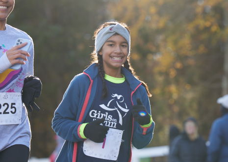 A Girls on the Run participant runs during the end of season 5K